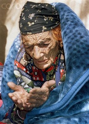 OLD WOMAN PRAYS AFTER SURVIVING EARTHQUAKE