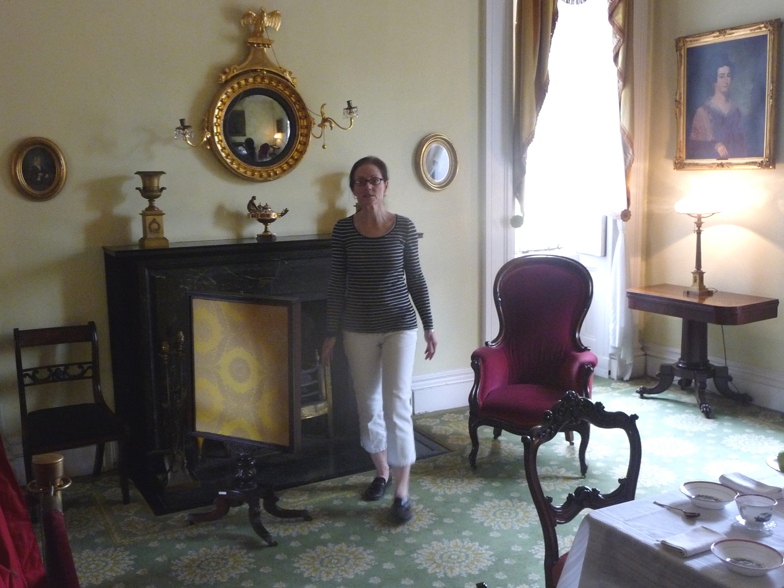 Our guide showing some of the exquisite 19th century furnishings in the more-casual sitting room.