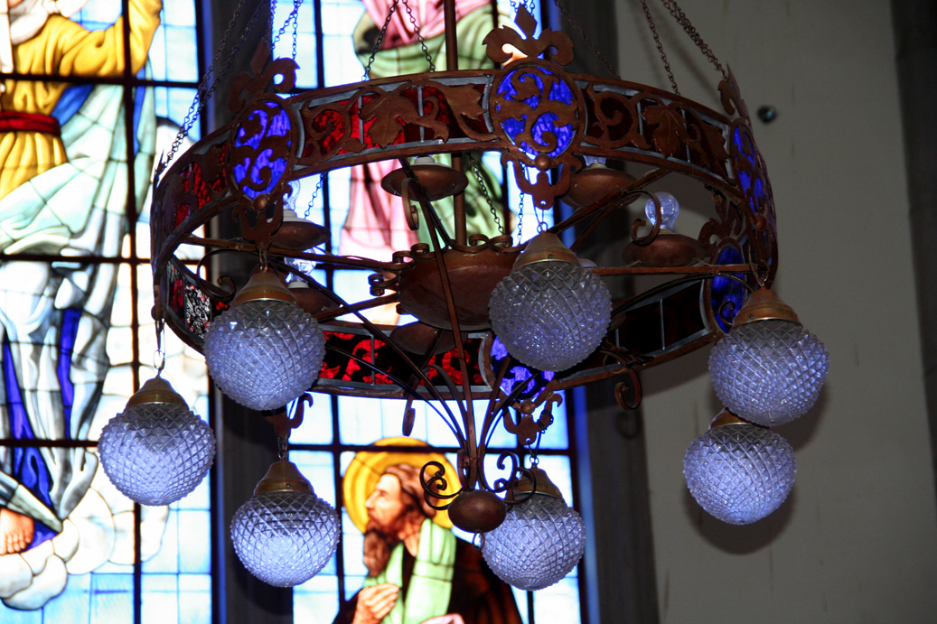 The chandeliers in the Basilica of Suyapo reflected some of the vibrant colors off of the stained glass windows.