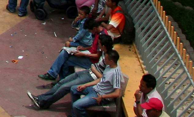 These people were watching the demonstration from the sideline of the park bench.
