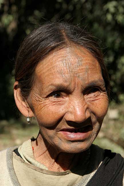 Khiamniungan Naga lady near Noklak with tattoos that shall ward off tigers.