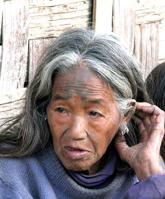 Chang Naga lady in Tuensang Village with tattoos that shall ward off tigers.