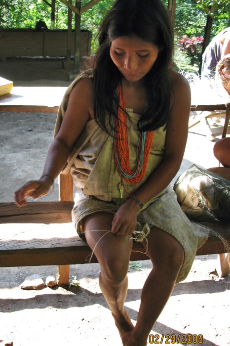 our bag weaver, demonstrating her technique for twisting twine