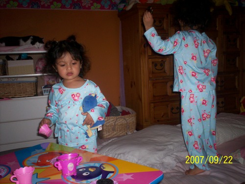 Two lil monkeys jumping on the bed