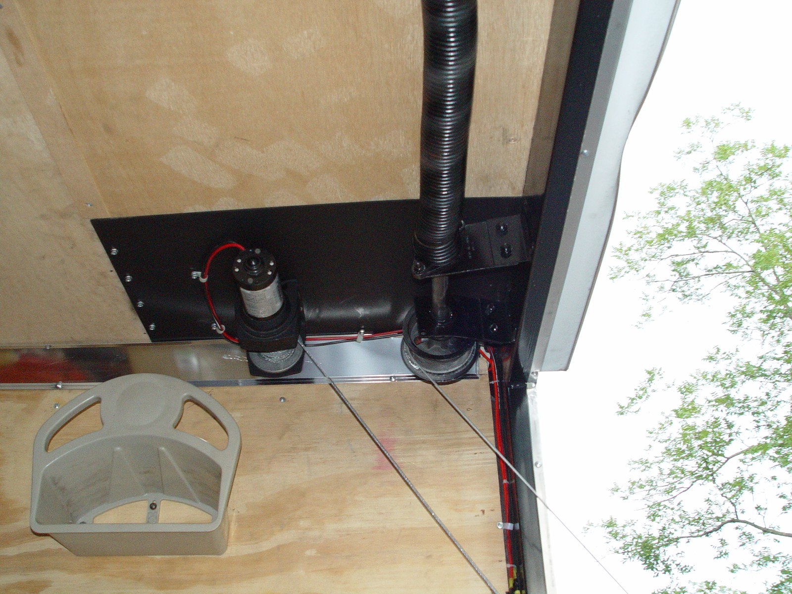THE 12 VOLT WINCH MOUNTS OVER THE FRAME WORK IN THE REAR AND SIDE AND BOLTS TO THE UNDERSIDE OF THE FORWARD FRAME PIECE