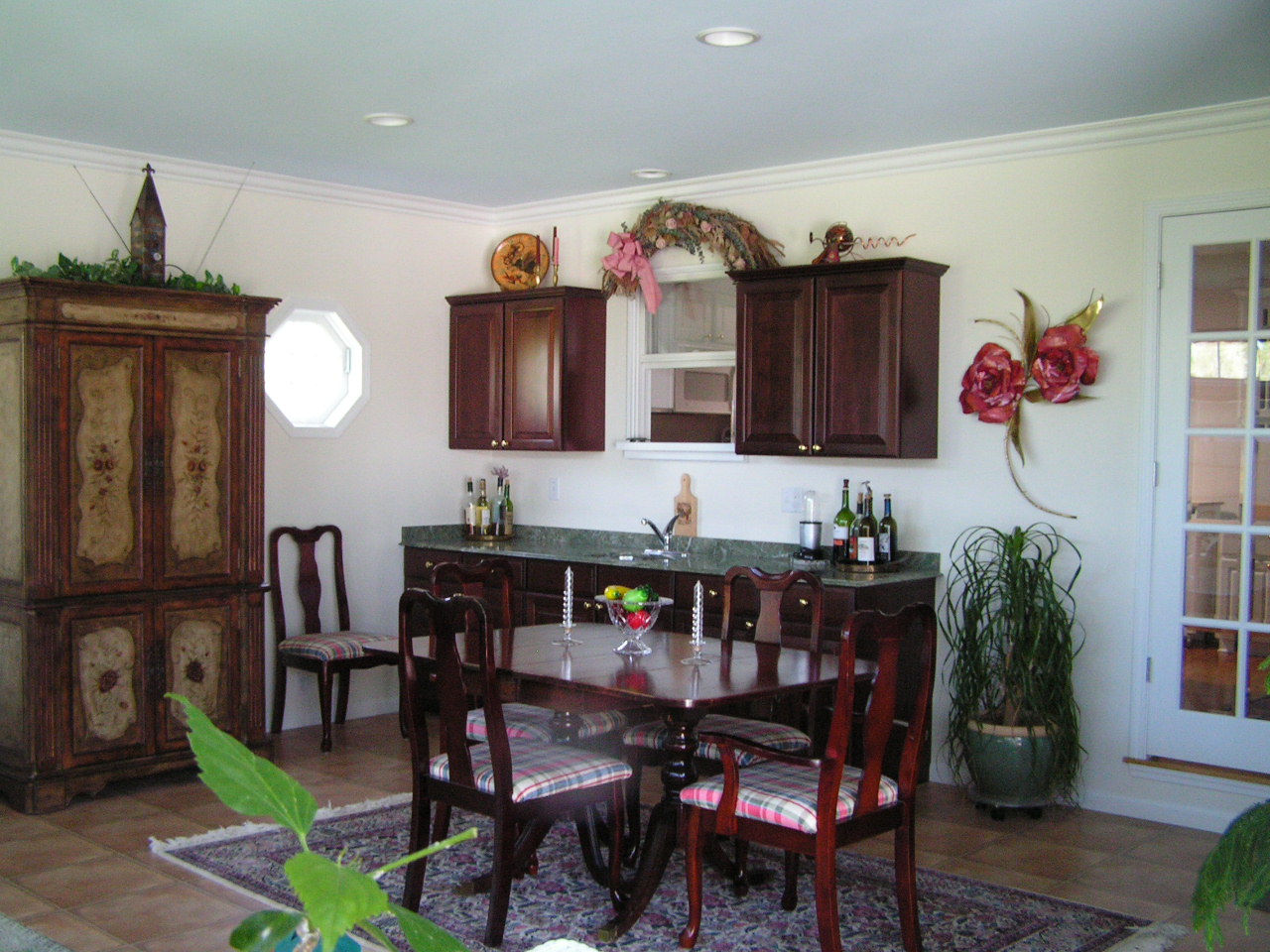 An extra window lights the beautiful formal dining area. Notice the crown molding.