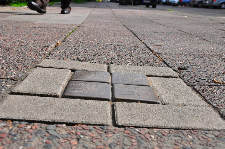 stumbling blocks-brass plaques sidewalk memorial to the people lived near by