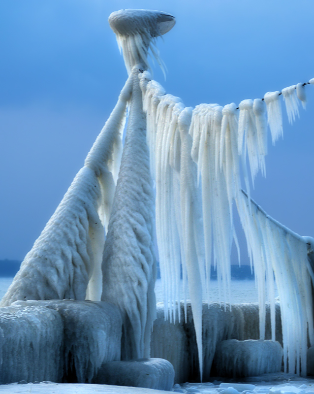A surrealistic gigantic praying mantis of ice…