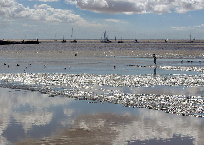 on glittering sand and water.