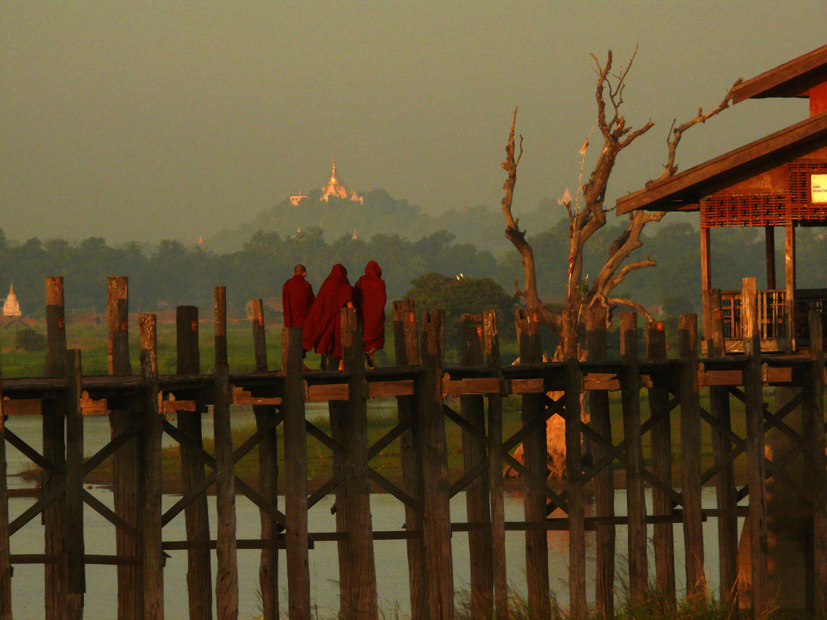 Three monks on U Bein Bridge in the morning.jpg
