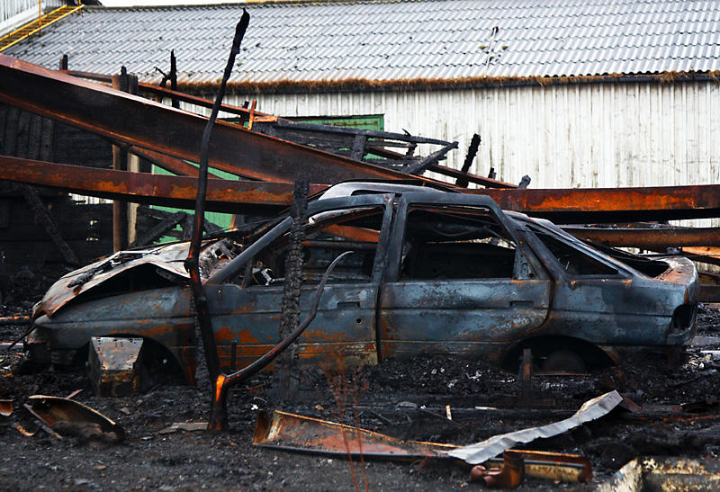 Burnt car in burnt building
