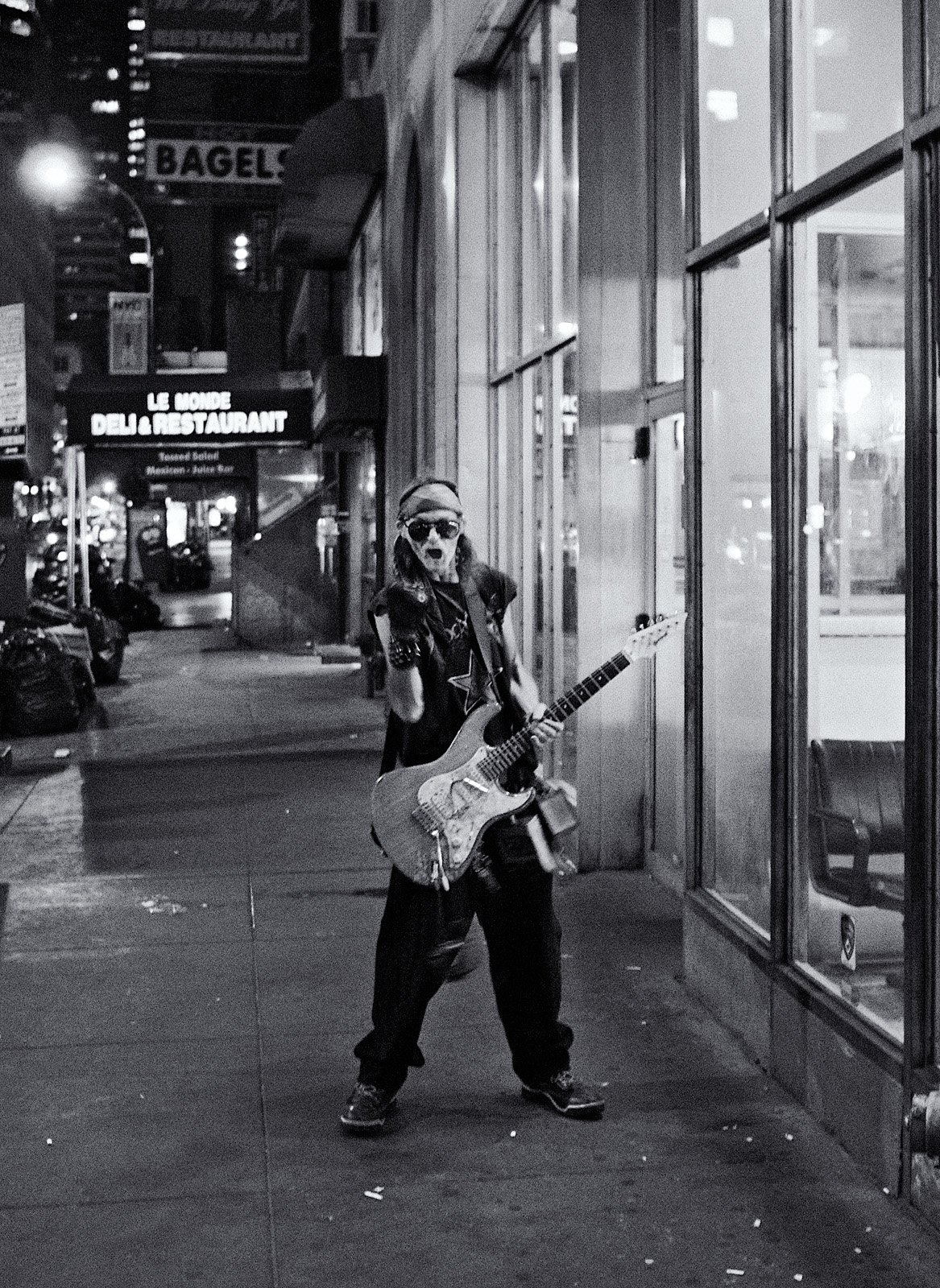 musician in front of OTB Midtown bw