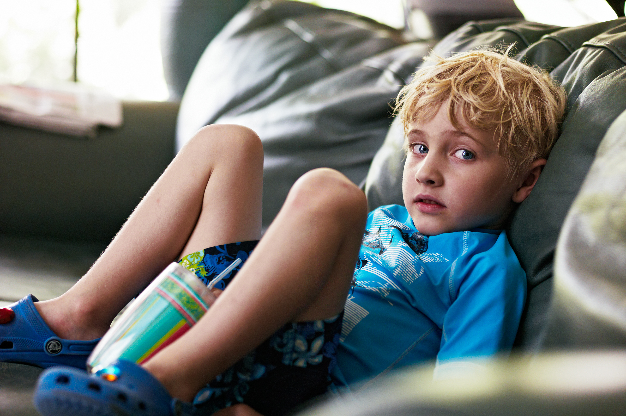 Phil on sofa watching cartoons