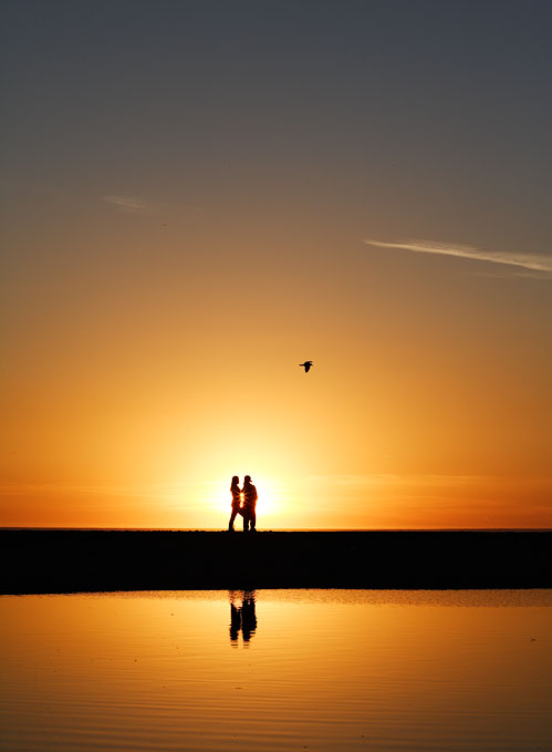 Couple playing at sunset