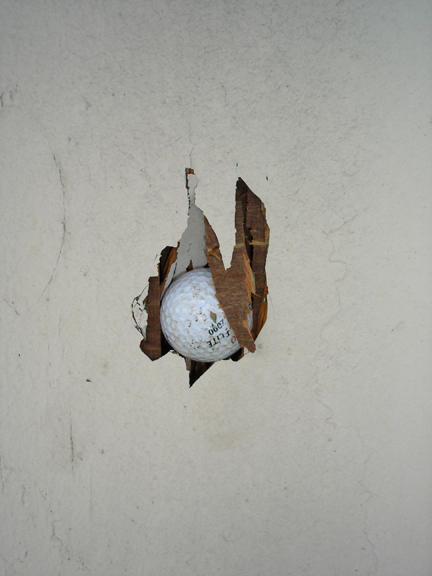 Golfball stuck in plywood building