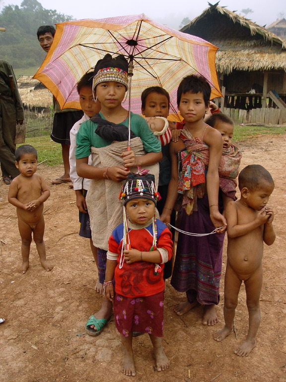 Older girls looking after children while parents work in the forest
