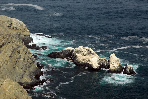 Rocks off the coast of Peru covered in bird guano