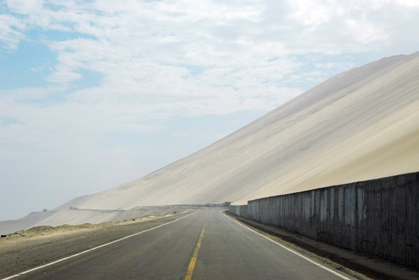 Concrete wall attempting to hold back the massive sanddunes, Panamerican Highway