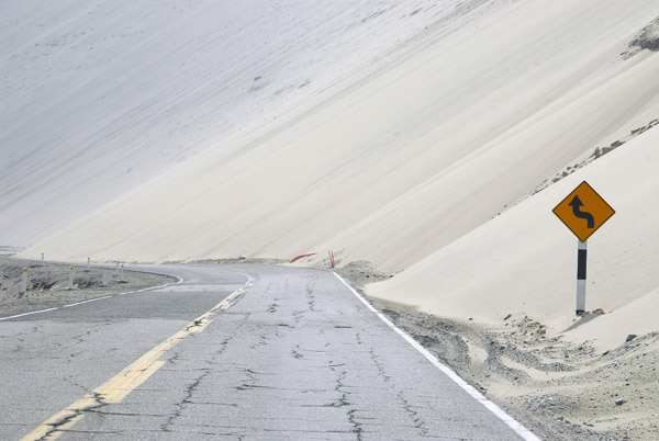 Sanddunes partially blocking the road ahead