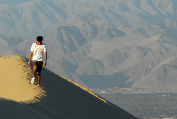 Man hiking a Huacachina dune