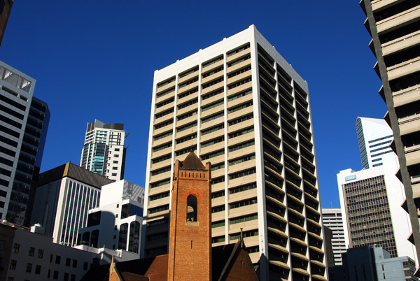 The tower of St Andrews Uniting Church dwarfed by the surrounding buildings