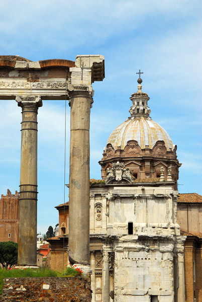 Columns of the Temple of Saturn with the dome of Santi Luca e Martina