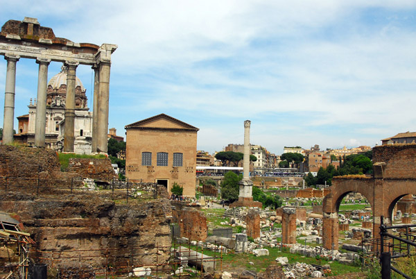 The Roman Forum with the colonnade of the Temple of Saturn and the Curia Julia (the simple brick structure built in 44 BC)