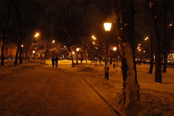 Walking through the park along Olimpiyskiy Prospekt at night