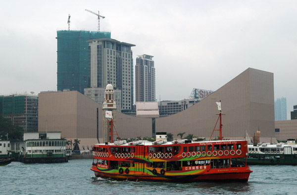 A Star Ferry painated red Hong Kong - Asia's world city with Hong Kong Cultural Centre, Kowloon