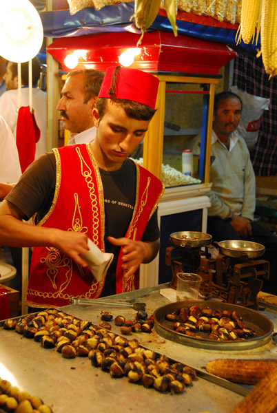Boy in a Turkish costume preparing snacks