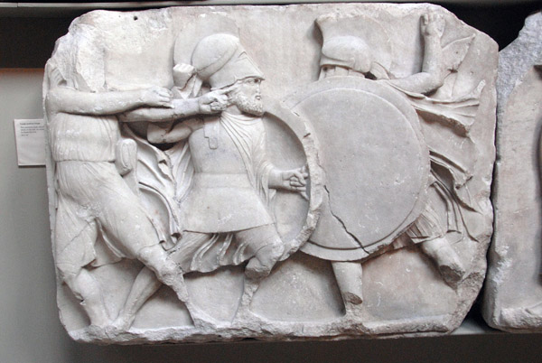 Large podium frieze - two warriors clash with an archer drawing his bow, British Museum