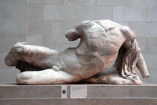 A naked youth reclines in a pose well suited to the corner angle of the Parthenon West Pediment representing the River Ilissos