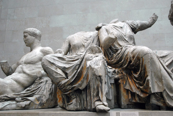 Two goddesses seated on chests, thought to be Demeter and Persephone, next to Dionysos, Parthenon East Pediment