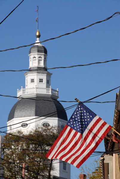 American flag with the Maryland State House dome