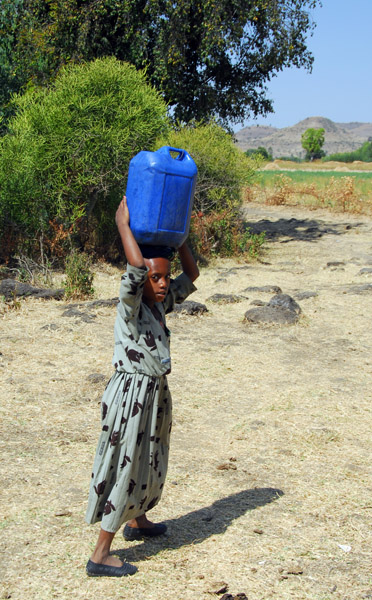 Girl fetching water from the river