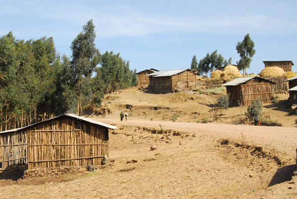 Highway 3, now a dirt road, passing through a village