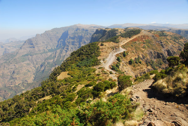 The trail descends to rejoin the park road