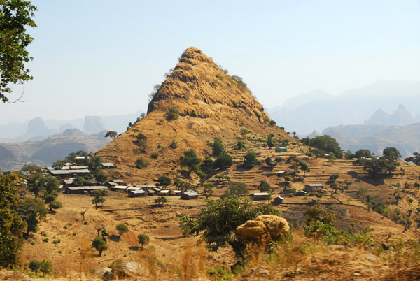 Shark's tooth peak with a small village