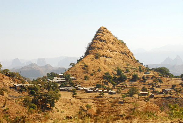 Shark's tooth peak with a small village