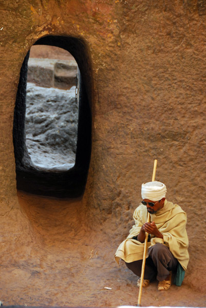 Monk at the passageway to the second church