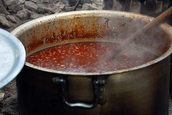 Stirring a vat of Ethiopian food prepared for a wedding
