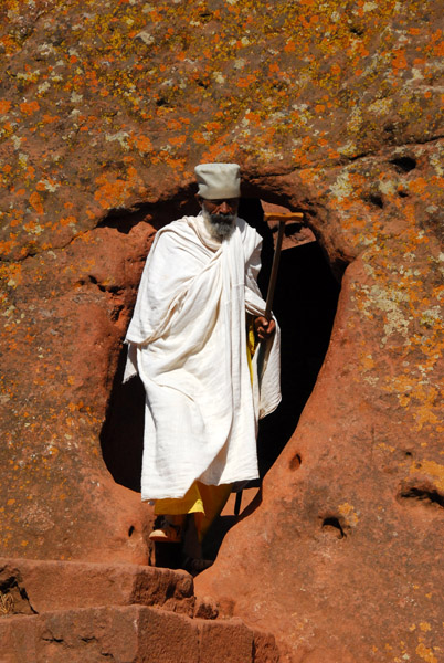 Priest emerging from a passage, Lalibela
