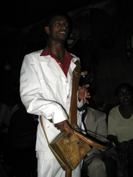 Azmari (Ethiopian minstrel) playing a masenqo