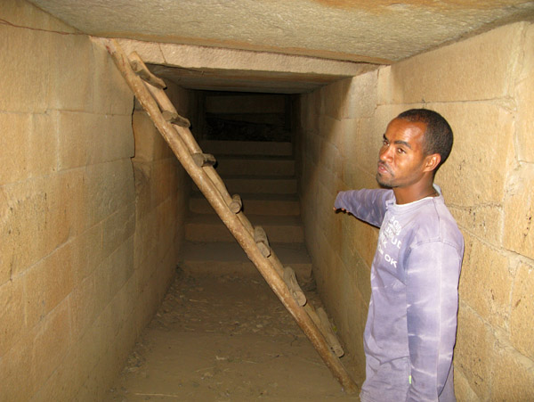 Guide pointing out the original entrance by stairs