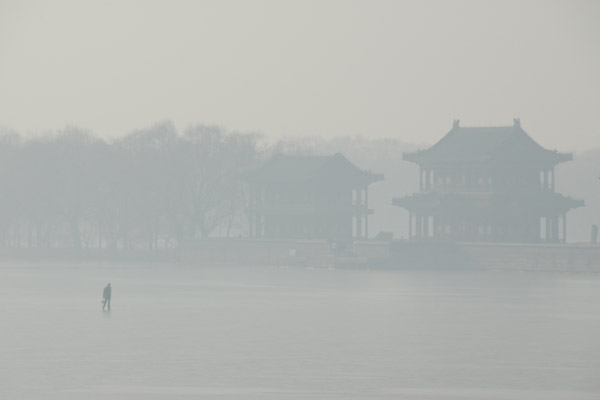 Misty image of a man walking across the ice of Kunming Lake