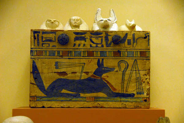 Wooden box painted with Anubis in the form of a jackal containing four canopic jars