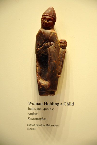 Carved amber of woman holding a child, 500-400 BC