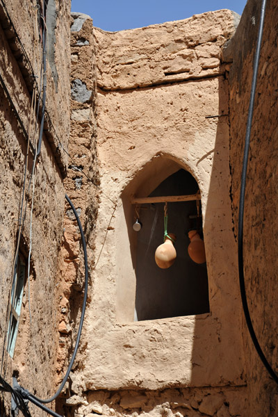 Ceramic water vessels hung in a window