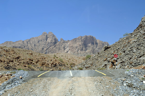 The new paved road runs above the wadi