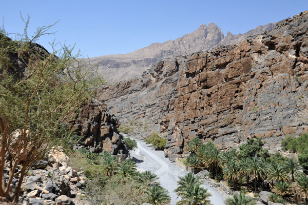 The road passes through a narrow section of Wadi An Nakhur